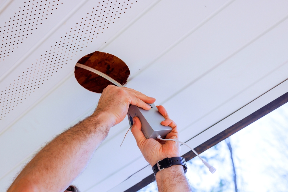 Electrician repairing a home light fixture