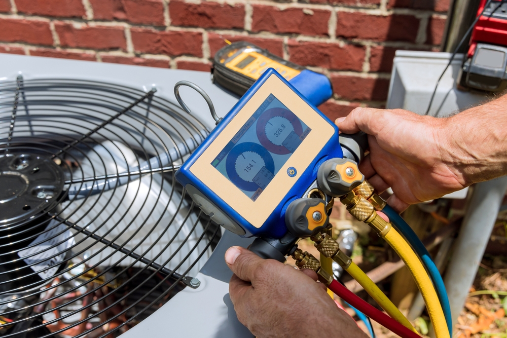 Technician inspecting a home heating and cooling system